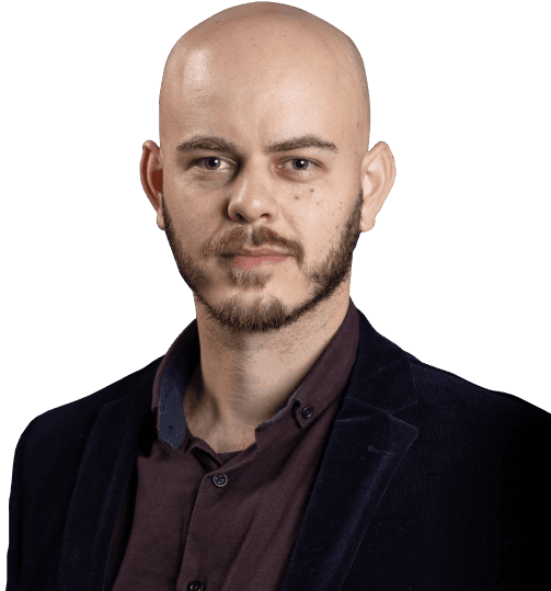 This is my photograph. I have a bald head, green eyes, and Caucasian ethnicity. I'm wearing a dark purple shirt paired with a navy blue blazer. I`m with a calm expression.